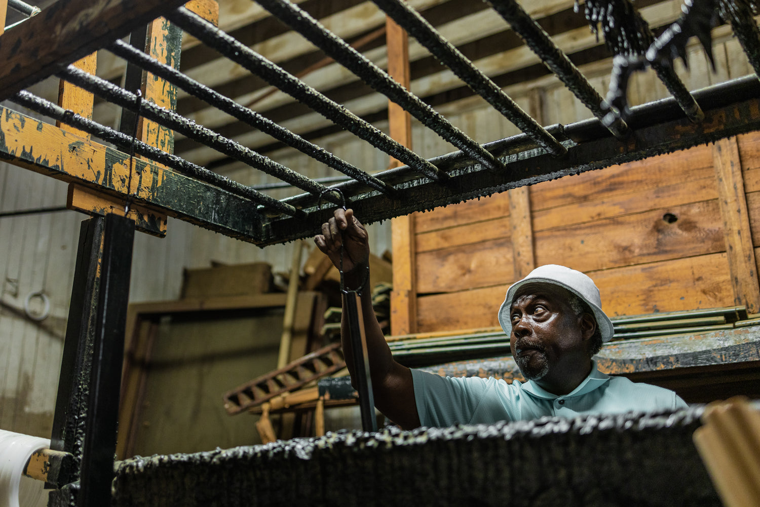 An authentic Charleston Battery Bench cypress slat is hand-dipped in enamel by one of our bench craftsmen.